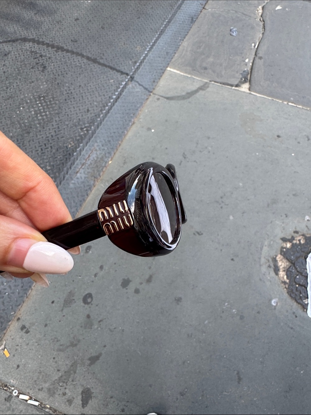 Miu Miu Black Oval Sunglasses with Dark Lenses